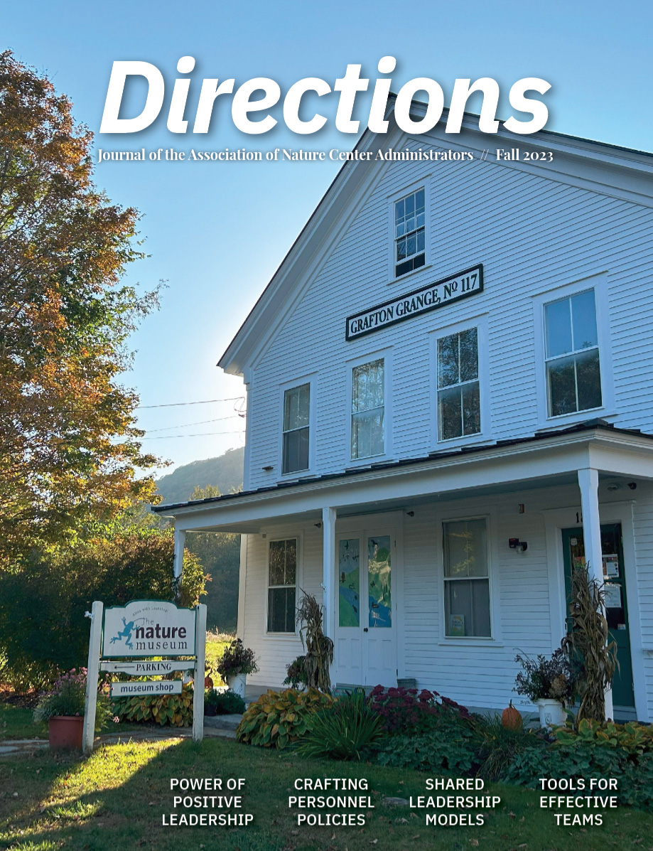 Cover of Directions, featuring a white A-frame building. Behind the building the sun shines. To the left is an autumnal tree with orange, yellow, and green leaves.