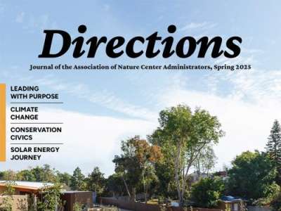 The "Directions" journal cover, featuring a photo of blue sky with light clouds, set against a treeline.