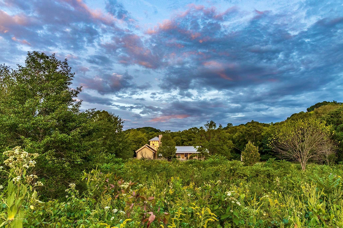 web View of the main Warner Park Nature Center building across a field in late summer - Laura Cook copy